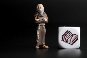 miniature figurine of a monk with a sacred book
