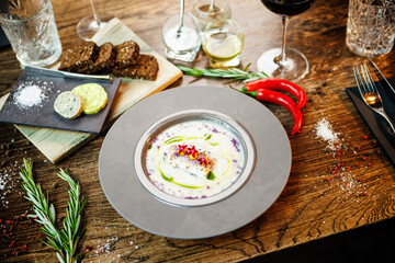 Jerusalem artichoke-almond cream soup with scallop roll. Leek, almond milk, garlic. Delicious healthy Jewish traditional food closeup served for lunch on a table in modern gourmet cuisine restaurant