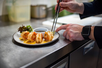 man chef cooking tasty shrimp on kitchen