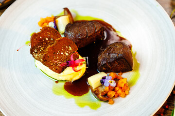 Deer tenderloin. Truffle-potato puree, porcini mushrooms, baked leek and carrot, juniper bread, port wine sauce. Delicious healthy traditional food served for lunch in modern gourmet restaurant
