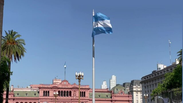 Flag of Argentina in Plaza de Mayo (English: May Square), with the Casa Rosada (English: Pink House) in the Background in the City Centre of Buenos Aires. 4K Resolution.