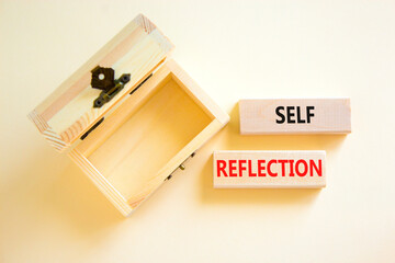 Self reflection symbol. Concept word Self reflection typed on wooden blocks. Beautiful white table...