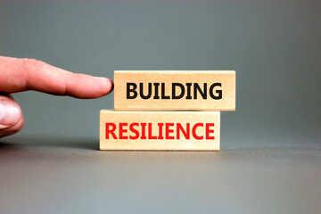 Building resilience symbol. Concept word Building resilience typed on wooden blocks. Beautiful grey...
