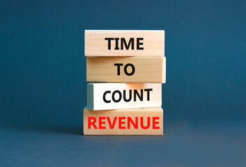 Time to count revenue symbol. Concept word Time to count revenue on wooden blocks. Beautiful grey table grey background. Business and time to count revenue concept. Copy space.