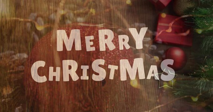 Animation of christmas greetings text over christmas tree and decorations