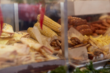 Street food, grilled sausages and corn on the fair. Fast food. Outdoor city fair