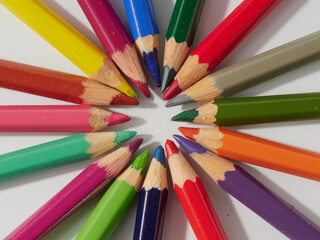 Fototapeta premium Colored pencils background. Colored pencils on a white background.