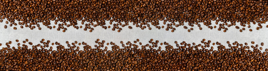 Roasted coffee beans background light concrete texture.