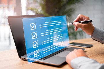 Digital work checklist on virtual screen concept, Businessman use a pen point on checklist and use...