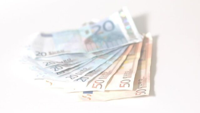 Animation of euro currency banknotes falling on white background