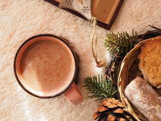 Cup of hot chocolate, cookies and fir branches on a white fluffy background