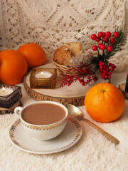A cup of hot chocolate, cookies, oranges, candles, Christmas decorations