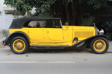Vintage yellow colour Rolls-Royce car. 