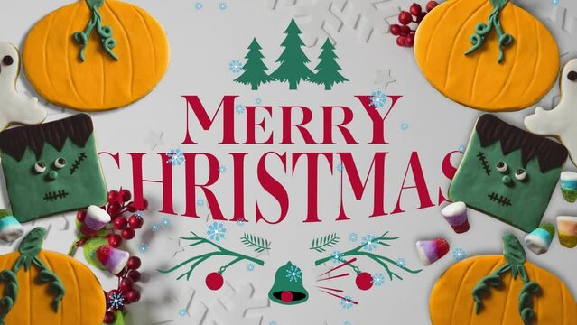 Animation of merry christmas over halloween and christmas decorations on white surface