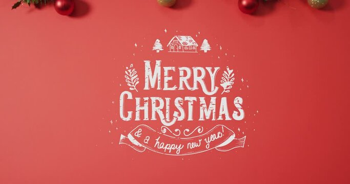Animation of christmas greetings text over baubles on red background