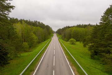 Drone photography of road going through forest