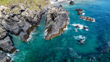 Steep cliffs on the coast of Ireland. Turquoise waters of the Atlantic Ocean. Natural beauties of Ireland, West Cork. The rocky coast of the Celtic Sea. Drone photo. © Oleksii