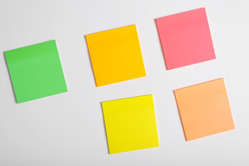 Multicolored self-adhesive blank stickers on a white background, mockup