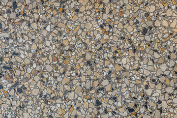 abstract background of decorative concrete texture filled with pebbles