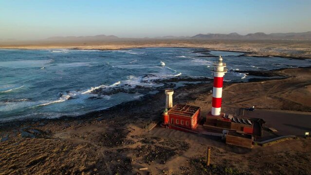 Marine landscape with lighthouse over sunset. aerial drone view, Fuerteventura . Canary island, El Cotilio village. El Toston lighthouse
