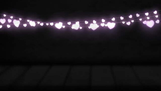 Animation of purple heart shaped glowing fairy lights hanging against copy space on black background