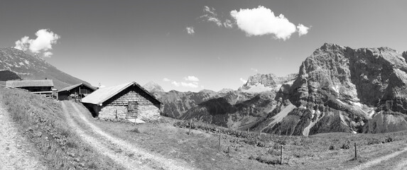 The north walls of Karwendel mountains -  Hahnkampl and Lamsen spitze peaks (right) and chalets over the Enger valley.