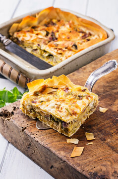 Traditional Turkish b&ouml;rek pastry with feta cheese, and vegetable served as close-up in a backing casserole
