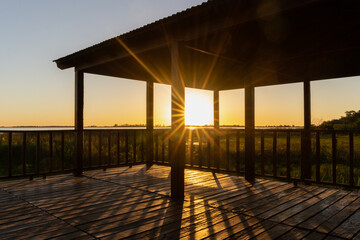 Beautiful wooden touristic viewpoint looking to Ibera Lagoon during sunset in Ibera Wetlands, Corrienteas, Argentina