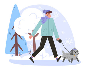 Young man walking with a small curly dog in winter forest