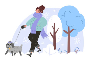 Young woman walking with a small curly dog in winter forest