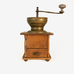 Coffee grinder on a white background. Old original coffee grinder with traces of time and scuffs on...
