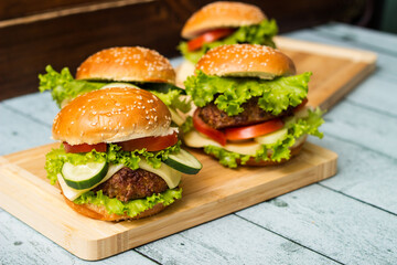 Fresh grilled burgers served on wood table
