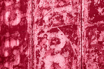 Old weathered painted surface with cracked paints magenta color trendy background