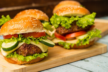 Fresh grilled burgers served on wood table