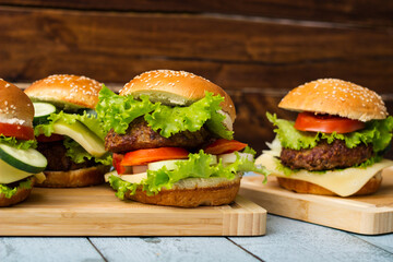 Fresh grilled burgers served on wood table