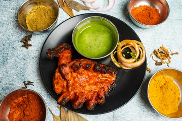 Spicy tandoori chicken Lal Badsha with chili sauce served in a dish isolated on grey background top view of bangladesh food