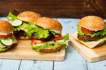 Fresh grilled burgers served on wood table