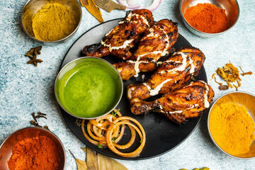 BBq chicken Tangri or tangdi with chili sauce served in a dish isolated on grey background top view...
