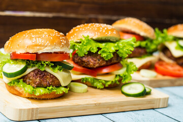 Fresh grilled burgers served on wood table