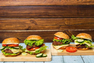 Fresh grilled burgers served on wood table