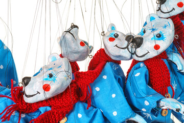 Lots of Bear puppets on strings in Christmas costumes close up