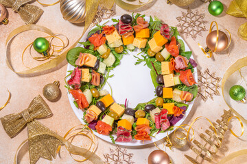 Christmas party dinner, trendy layout appetizers. Charcuterie wreath made from sausage, meat,...