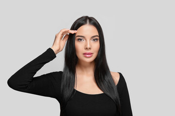 Fototapeta premium Portrait of beautiful young woman on light grey background