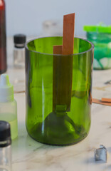a candle made of soy wax with a trimmed wine bottle. Manufacturing Process