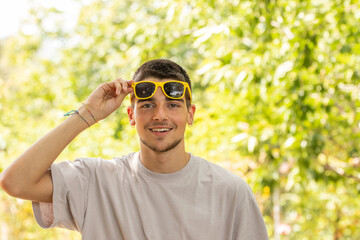 portrait of young man with sunglasses outdoors