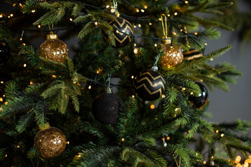 Christmas balls in black and gold on a Christmas tree