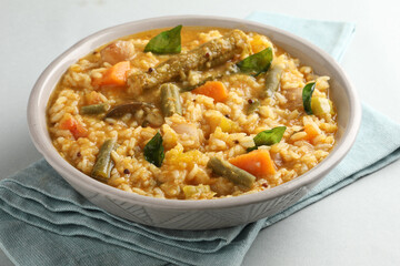 South Indian traditional and popular vegetarian rice dish, bisi bele bath, which has rice and...