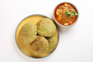 Indian Palak Poori Or Palak Puri Made Of Wheat Flour mixed with blanched Spinach Leaves Served with potato Sabzi Or Veg Curry Sabji.