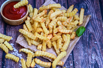  Home made   organic   Fresh fried French fries with ketchup saue  on wooden background