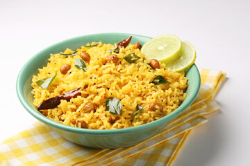 Lemon Rice or fodnicha bhat is South Indian turmeric rice or maharashtrian recipe using leftover rice garnished with nuts curry leaves and lemon juice
